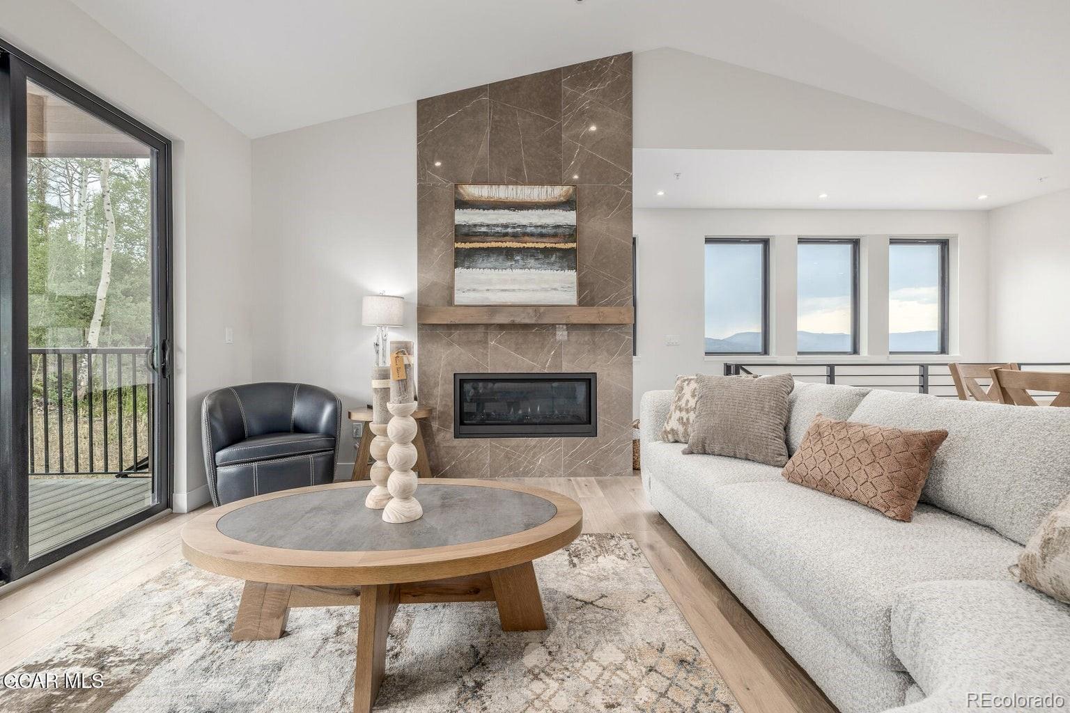 104 Saddle Mountain Camp Road Granby, CO 80446 - Photo 13 of 50 a living room with furniture and a fireplace
