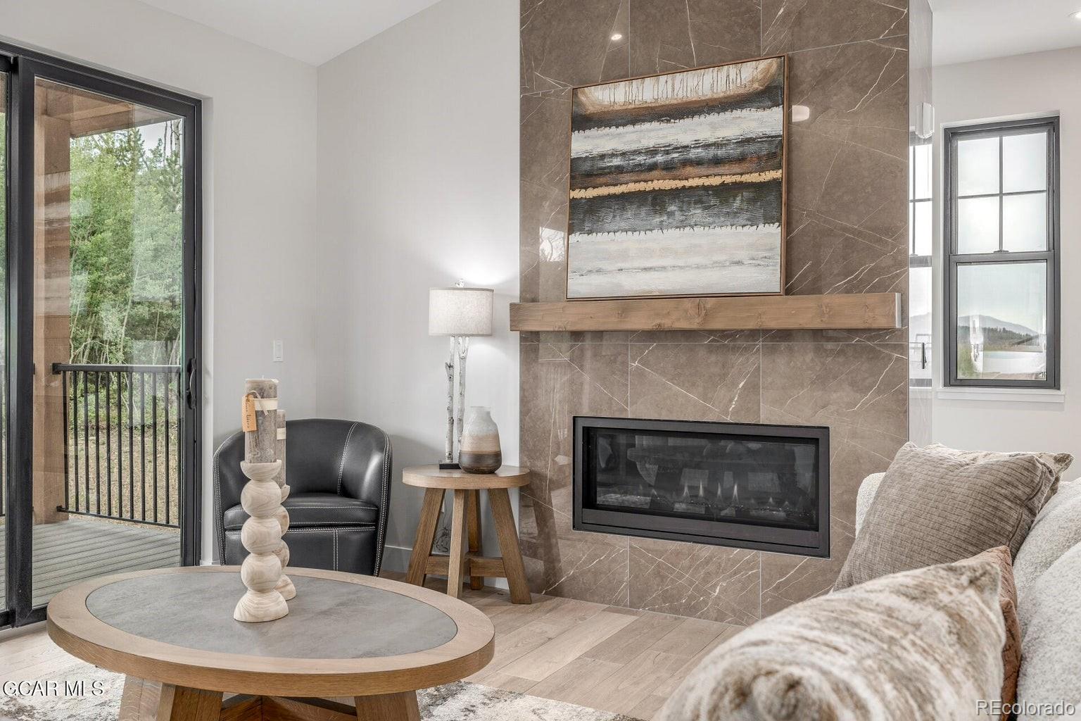 104 Saddle Mountain Camp Road Granby, CO 80446 - Photo 14 of 50 a living room with furniture a window and a fireplace
