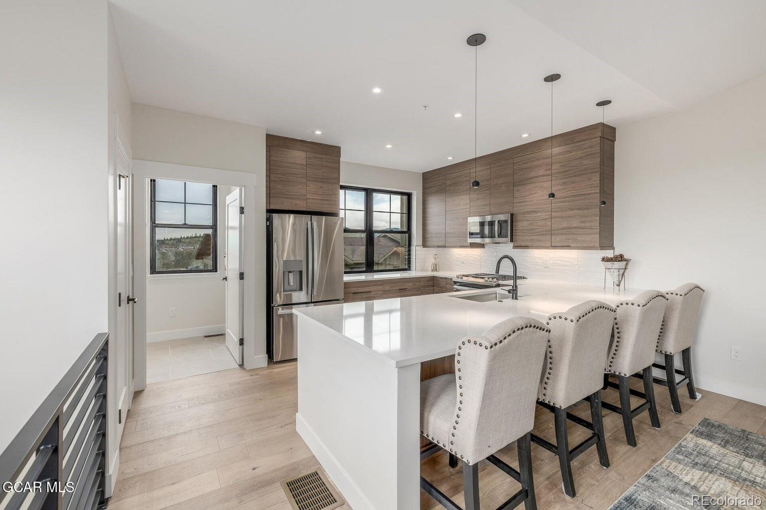 104 Saddle Mountain Camp Road Granby, CO 80446 - Photo 16 of 50 a large kitchen with a table and chairs