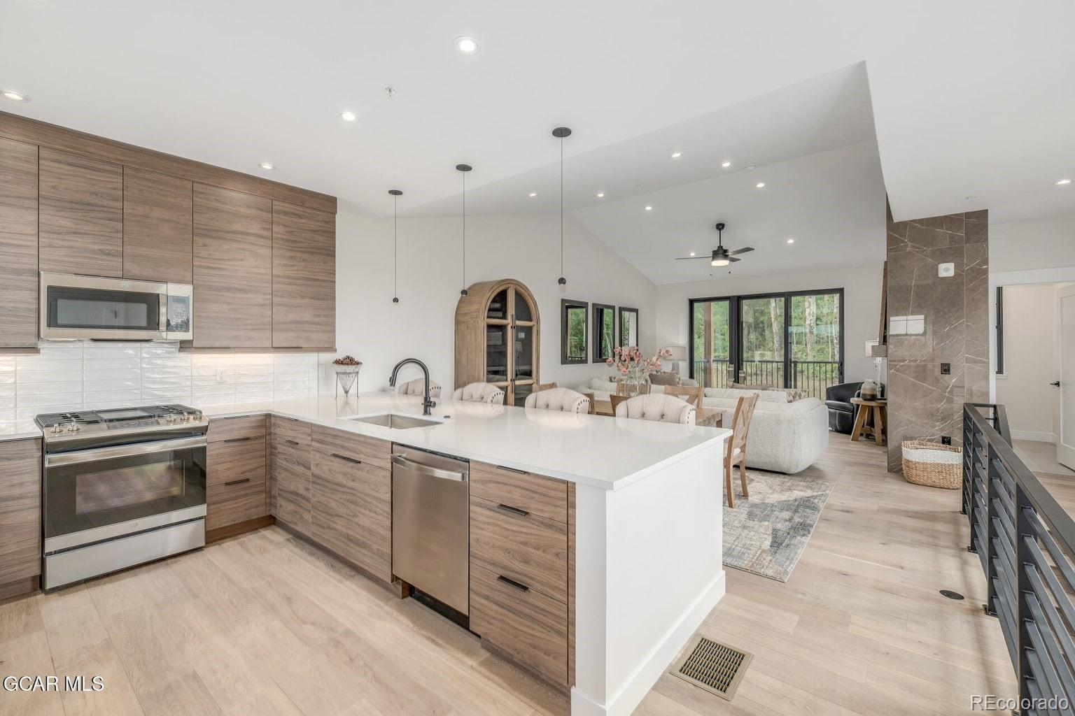104 Saddle Mountain Camp Road Granby, CO 80446 - Photo 19 of 50 a large white kitchen with a sink and cabinets