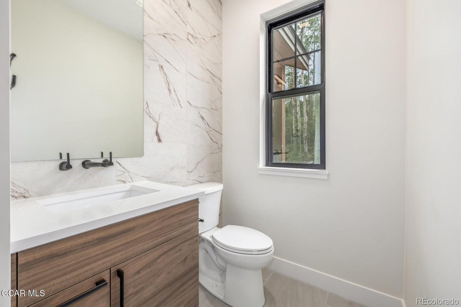 104 Saddle Mountain Camp Road Granby, CO 80446 - Photo 23 of 50 a bathroom with a sink a toilet and mirror