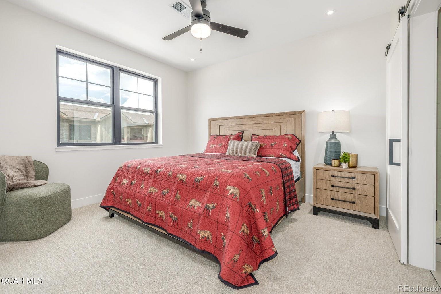 104 Saddle Mountain Camp Road Granby, CO 80446 - Photo 24 of 50 a spacious bedroom with a bed and ceiling fan