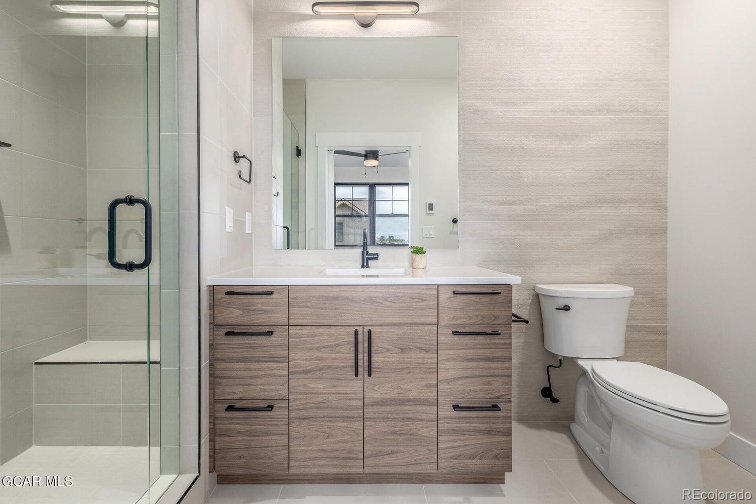 104 Saddle Mountain Camp Road Granby, CO 80446 - Photo 27 of 50 a bathroom with a sink vanity mirror and toilet