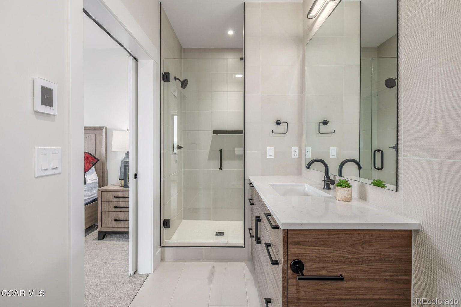 104 Saddle Mountain Camp Road Granby, CO 80446 - Photo 28 of 50 a bathroom with a sink double vanity and shower