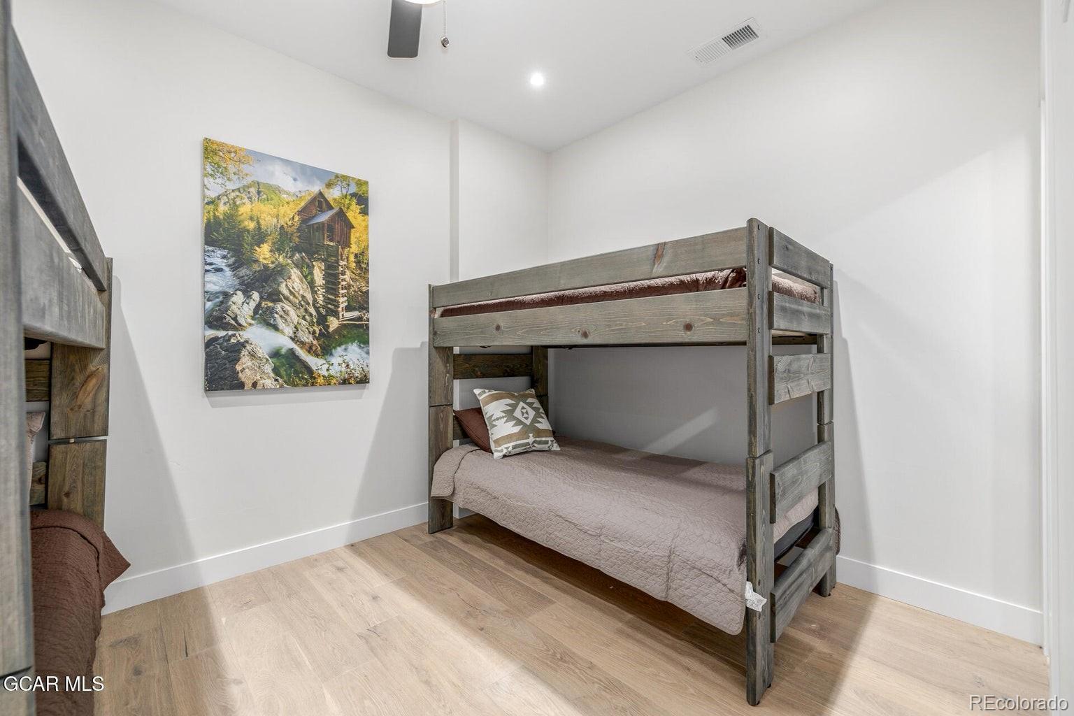 104 Saddle Mountain Camp Road Granby, CO 80446 - Photo 31 of 50 a bedroom with a bed and a painting on the wall