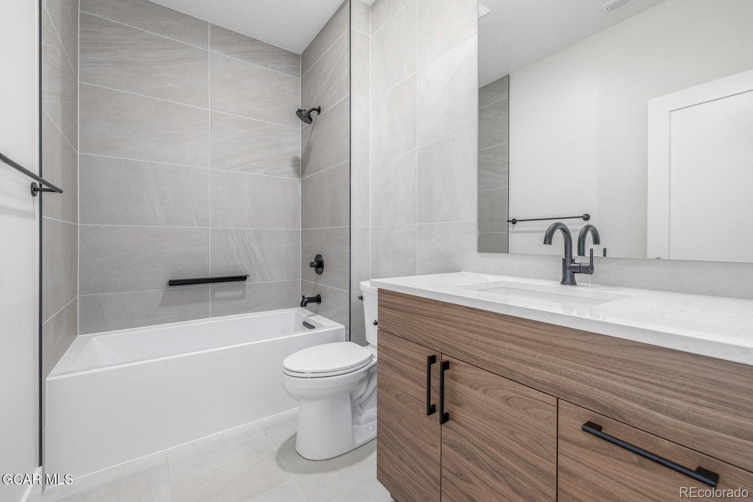 104 Saddle Mountain Camp Road Granby, CO 80446 - Photo 32 of 50 a bathroom with a sink a toilet and shower