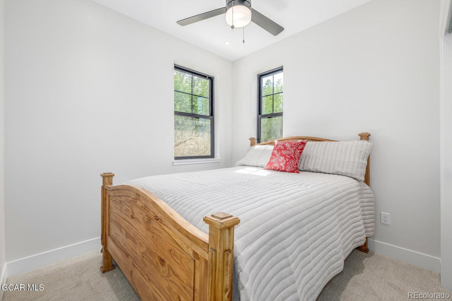 104 Saddle Mountain Camp Road Granby, CO 80446 - Photo 33 of 50 a bedroom with a bed and window