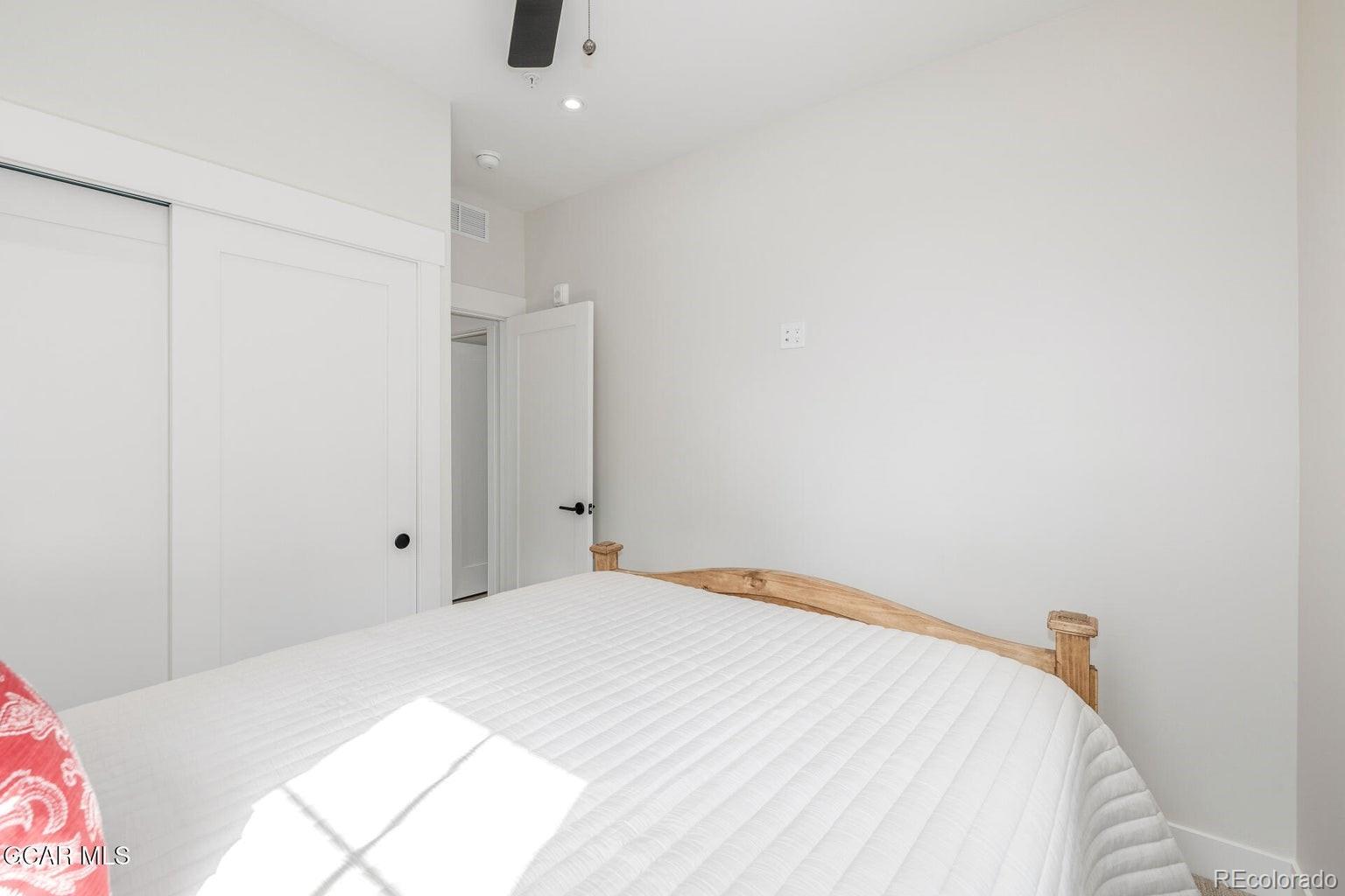 104 Saddle Mountain Camp Road Granby, CO 80446 - Photo 34 of 50 a bedroom with a bed and a wall painting