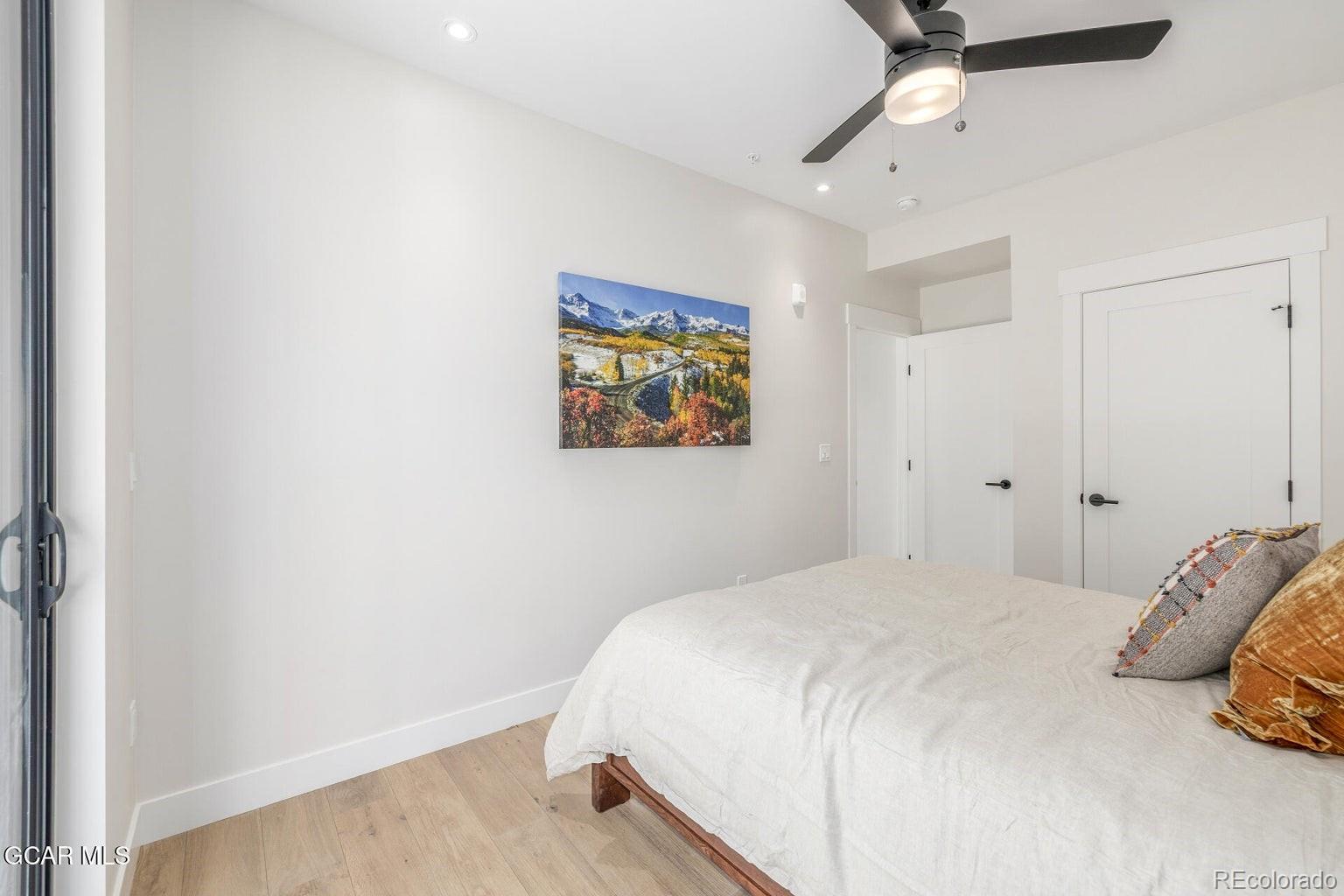 104 Saddle Mountain Camp Road Granby, CO 80446 - Photo 36 of 50 a bedroom with a bed and a painting on the wall