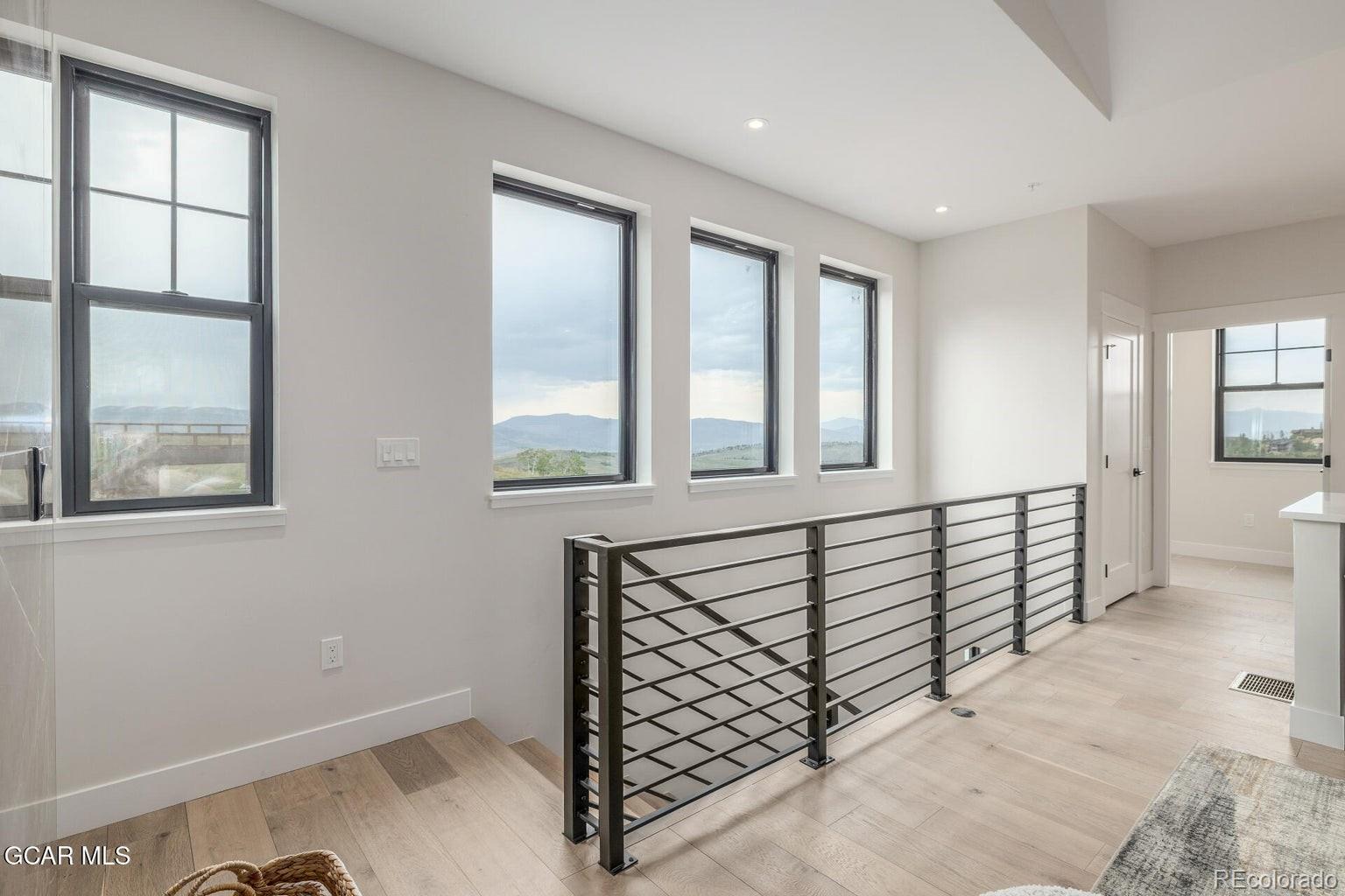104 Saddle Mountain Camp Road Granby, CO 80446 - Photo 41 of 50 a view of a hallway with windows and wooden floor