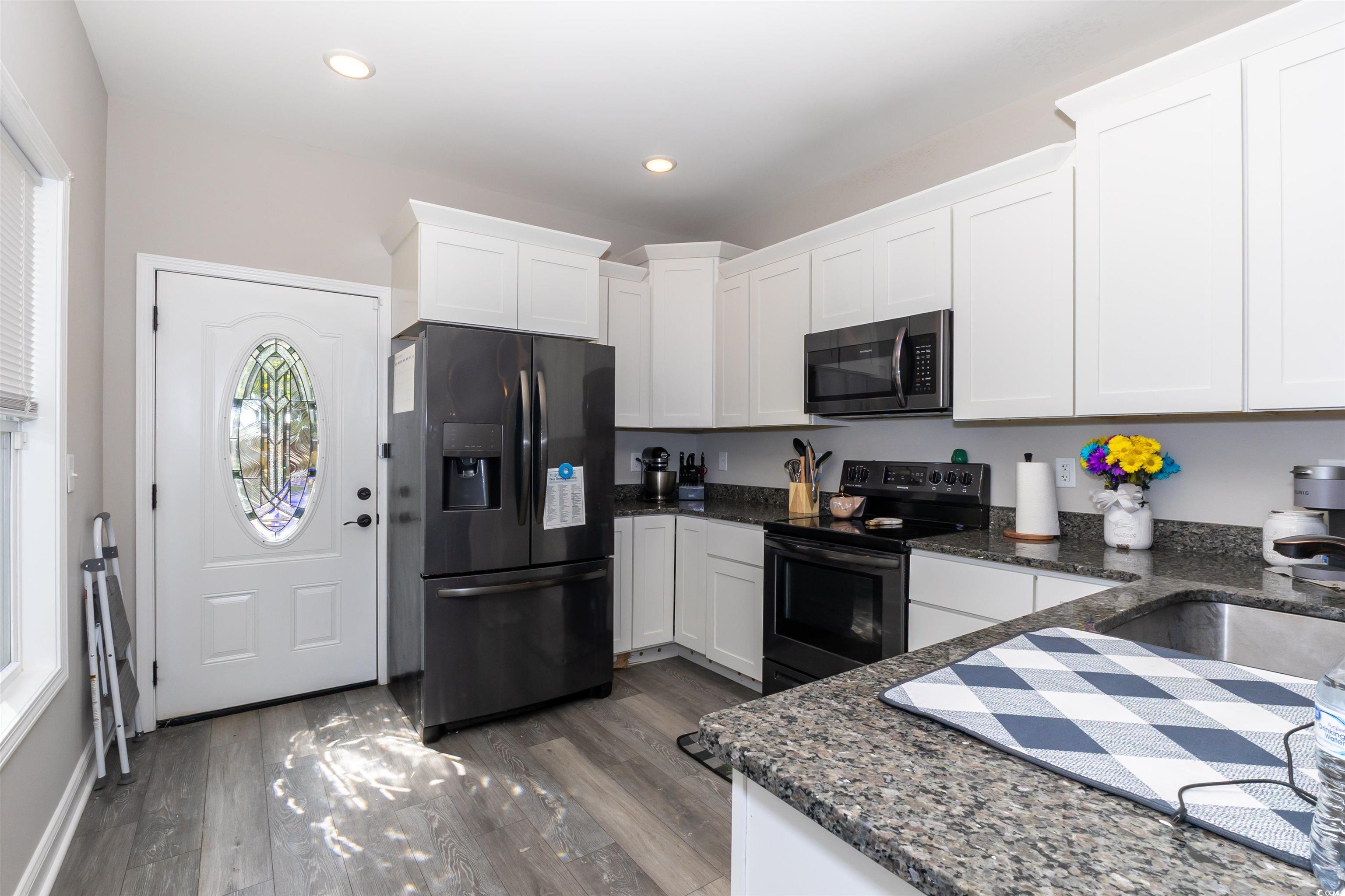 1501 Grainger Road Conway, SC 29527 - Photo 8 of 22 Kitchen featuring white cabinets, a sink, black ap