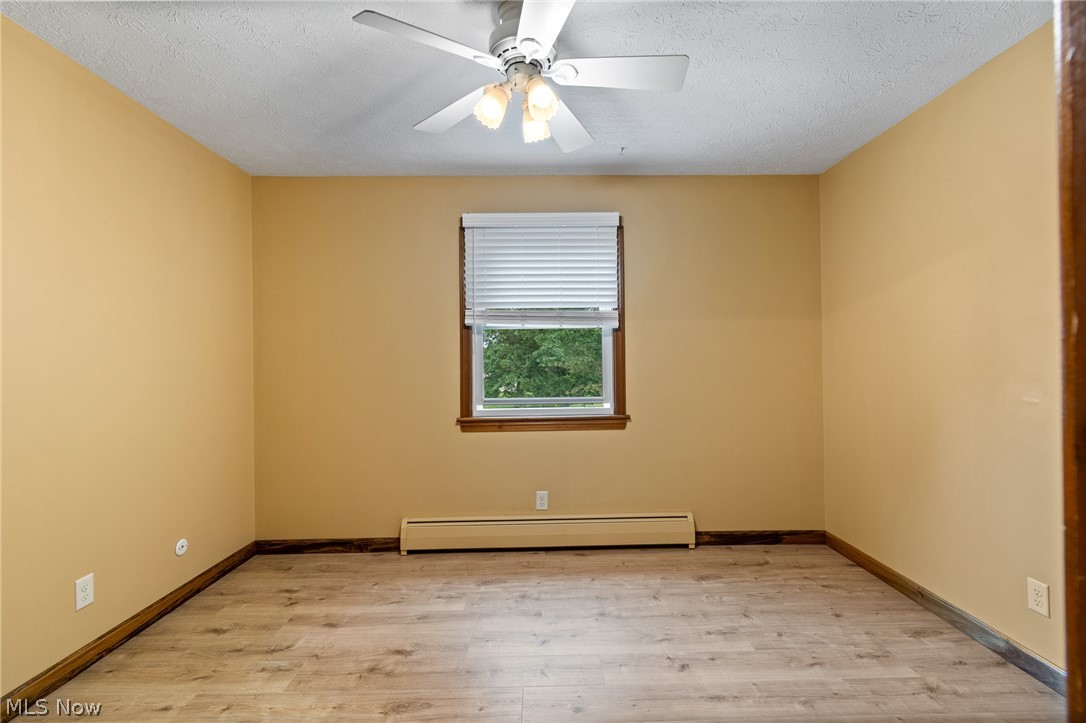 34 Kehner Road Mogadore, OH 44260 - Photo 26 of 40 Room with wood-finish flooring, a ceiling fan with integrated lighting, and a single window with blinds