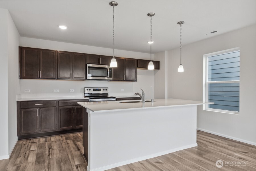 131 Willowbrook Drive Chehalis, WA 98532 - Photo 12 of 29 a kitchen with stainless steel appliances granite countertop a sink a stove and a wooden floors