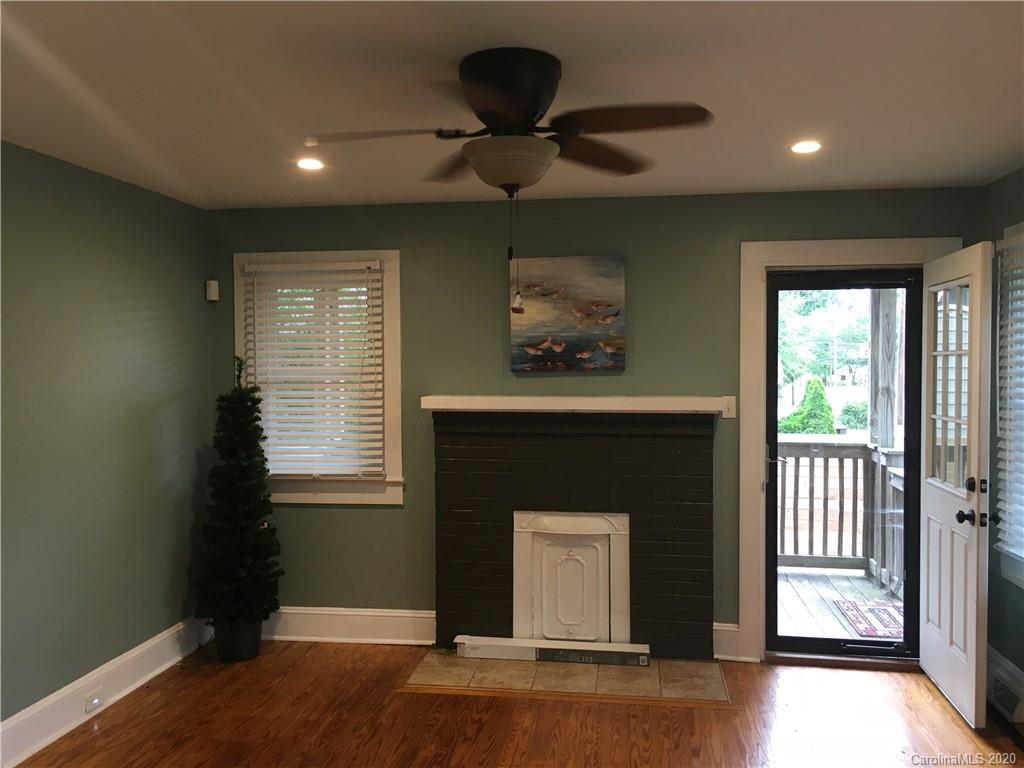 501 Union Cemetery Road Southwest Concord, NC 28027 - Photo 2 of 10 a living room with a fireplace and a window