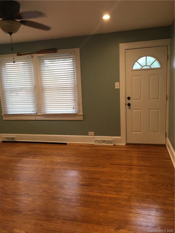 501 Union Cemetery Road Southwest Concord, NC 28027 - Photo 3 of 10 an empty room with wooden floor and windows