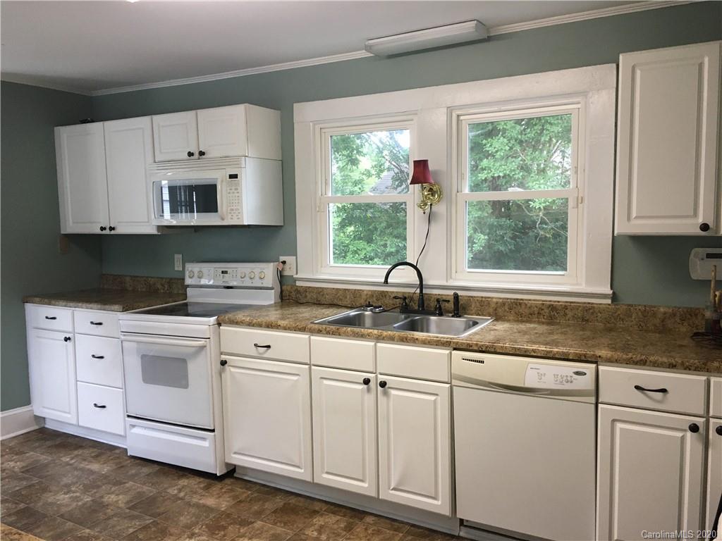 501 Union Cemetery Road Southwest Concord, NC 28027 - Photo 5 of 10 a kitchen with granite countertop white cabinets white stainless steel appliances and a sink