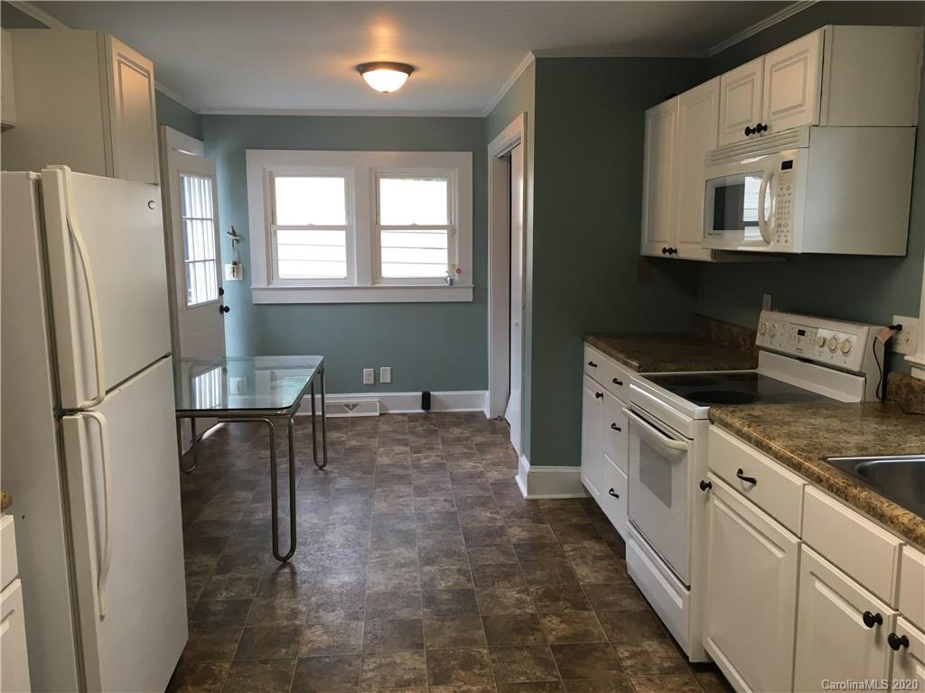 501 Union Cemetery Road Southwest Concord, NC 28027 - Photo 6 of 10 a kitchen with stainless steel appliances a refrigerator sink and white cabinets