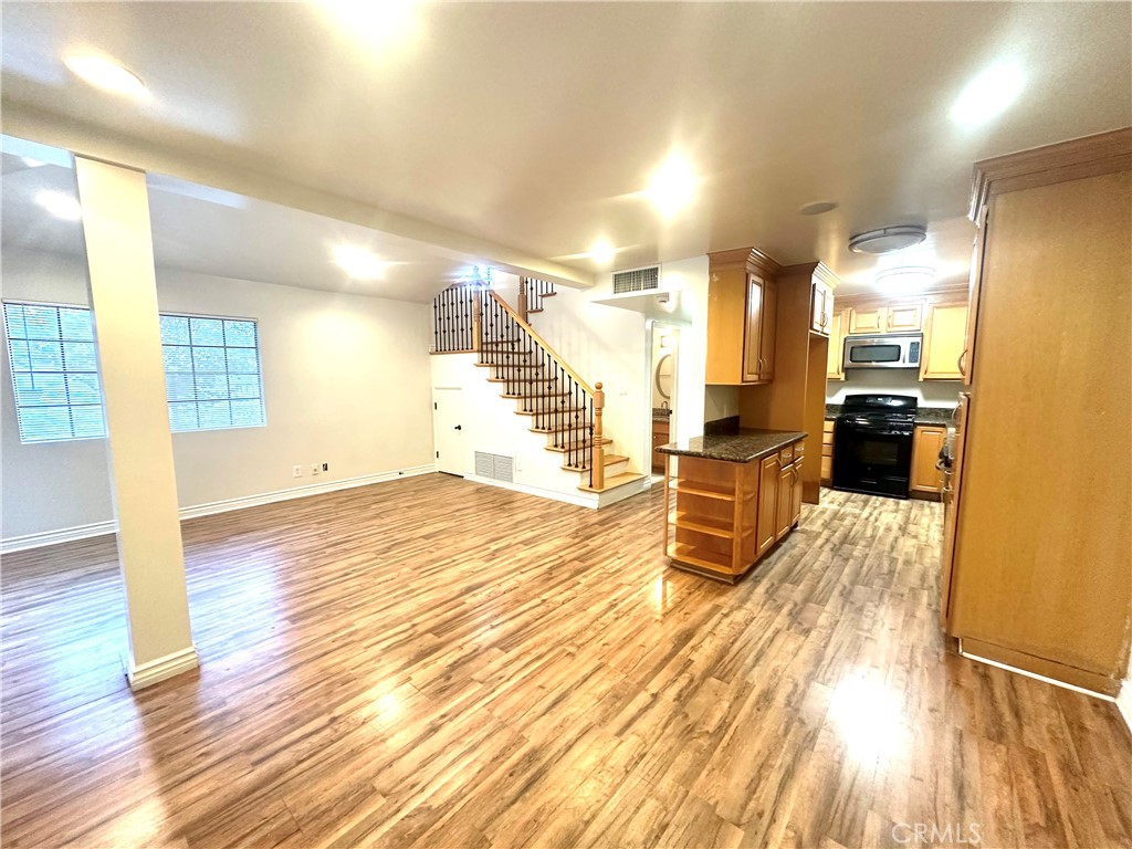 9356 19th Street, Unit A Rancho Cucamonga, CA 91701 - Photo 4 of 23 a view of a room with wooden floor and windows
