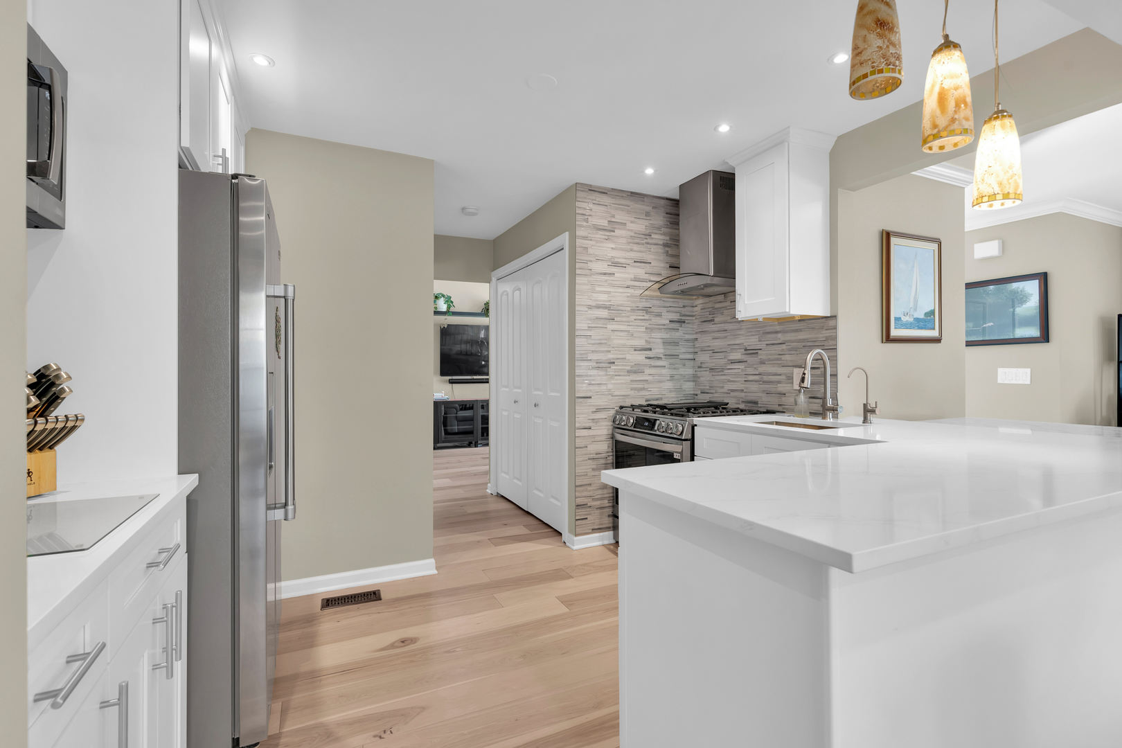 473 Le Parc Circle Buffalo Grove, IL 60089 - Photo 16 of 30 a large white kitchen with a sink and dishwasher a refrigerator with wooden floor