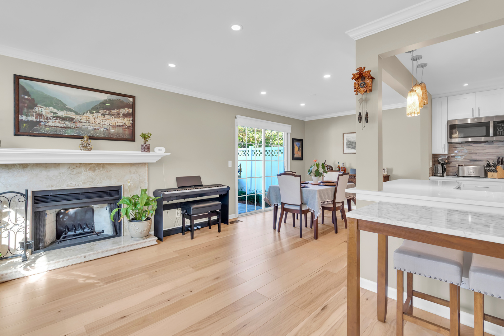 473 Le Parc Circle Buffalo Grove, IL 60089 - Photo 9 of 30 a living room with furniture a fireplace and a dining table with wooden floor