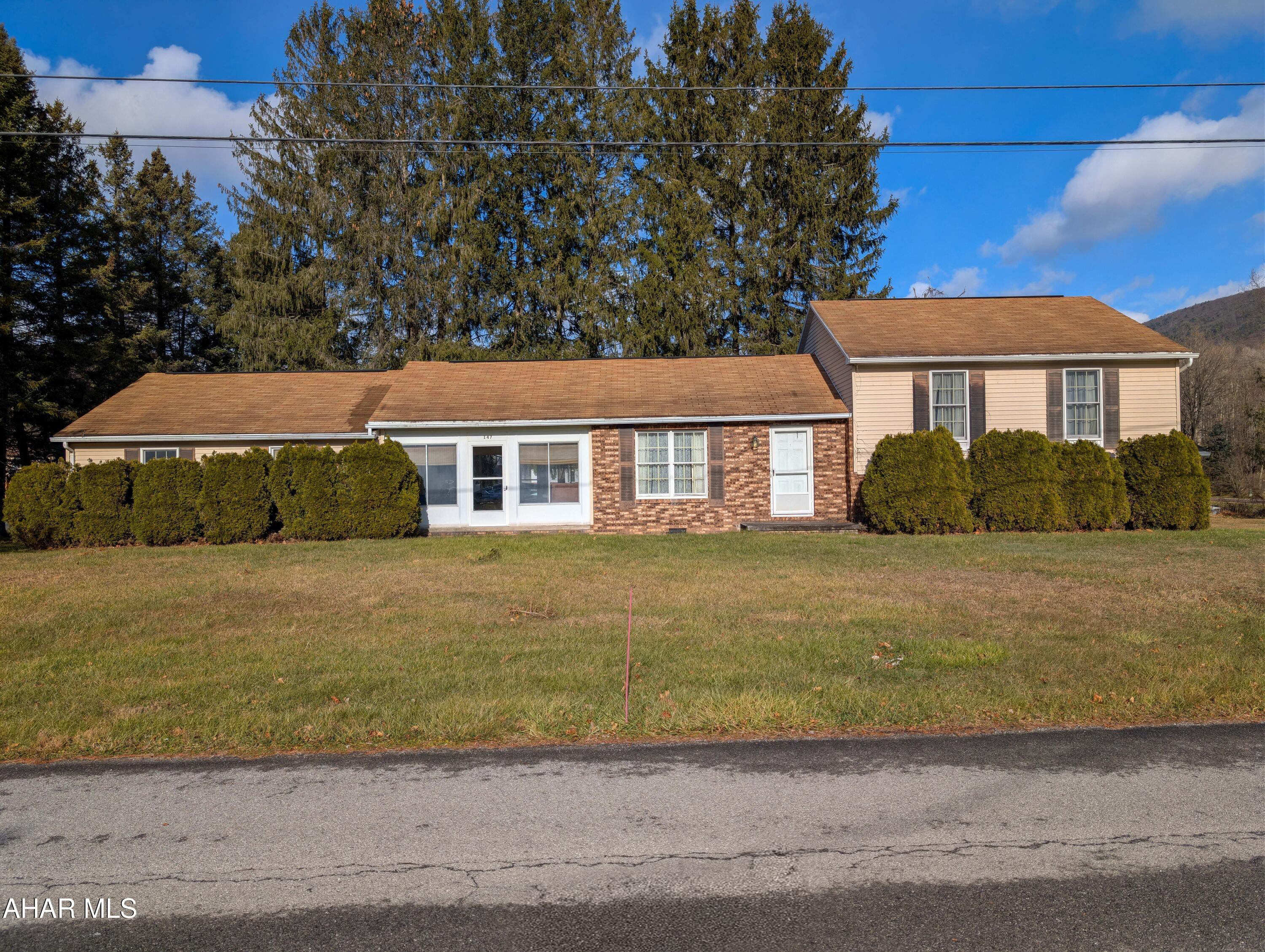 147 Pine Street Hyndman, PA 15545 - Photo 1 of 44 a front view of a house with a garden