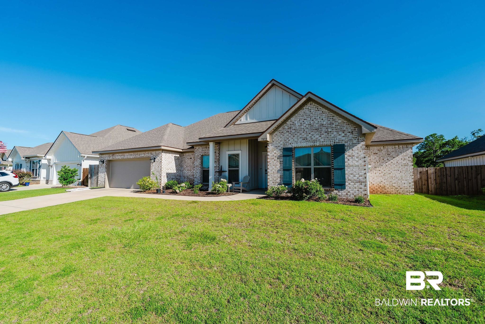 7872 Calverton Street Foley, AL 36535 - Photo 4 of 76 Contemporary ranch-style residence featuring a brick facade, gabled rooflines, an attached two-car garage, and a front porch