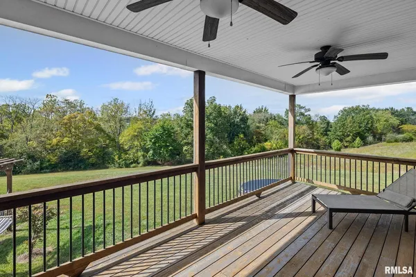 a view of a patio with a table and chairs under an umbrella