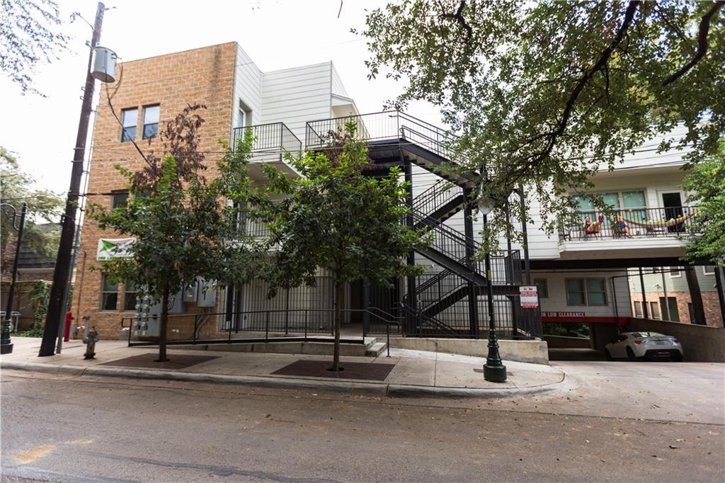 2708 San Pedro Street, Unit 302 Austin, TX 78705 - Photo 1 of 11 a building exterior with stairs and trees