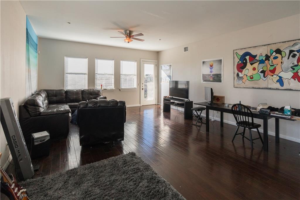 2708 San Pedro Street, Unit 302 Austin, TX 78705 - Photo 3 of 11 a living room with furniture floor to ceiling window and wooden floor