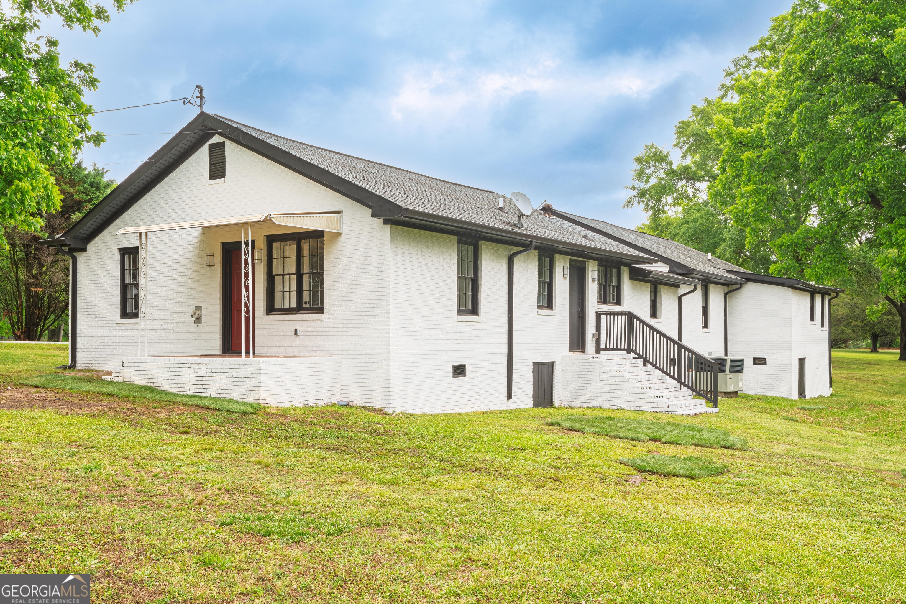 418 Lamb Road Moreland, GA 30259 - Photo 3 of 32 a front view of house with yard and trees in the background