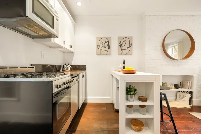 a kitchen with stainless steel appliances granite countertop a stove and a sink