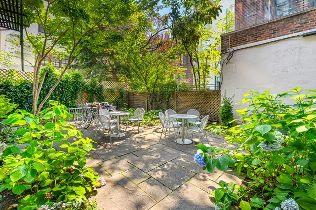 a backyard of a house with table and chairs