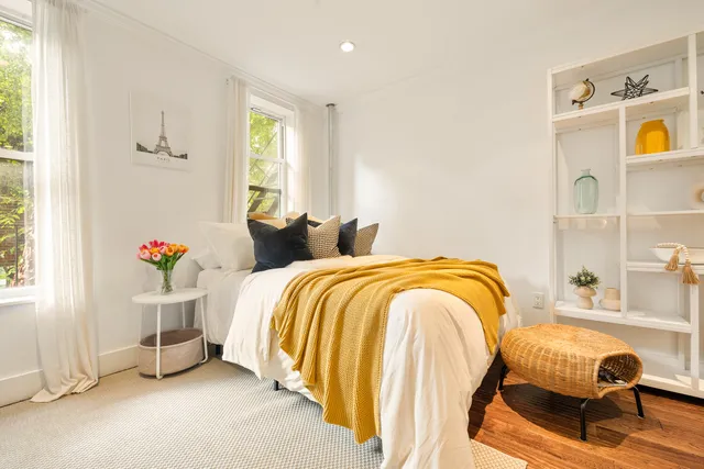 a living room with furniture and a mirror