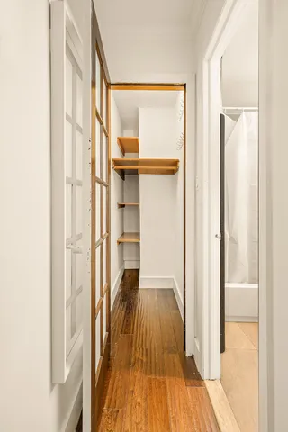 a kitchen with a sink cabinets and wooden floor