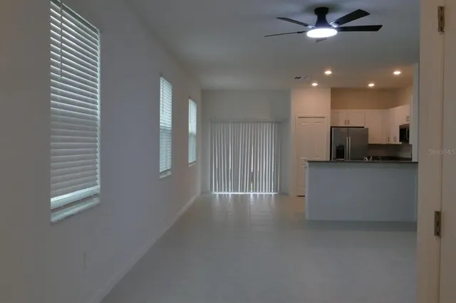 a view of a kitchen with an empty space and a window