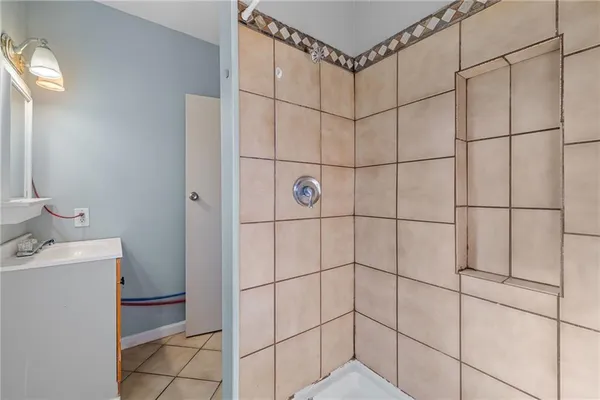 a bathroom with a shower and a sink
