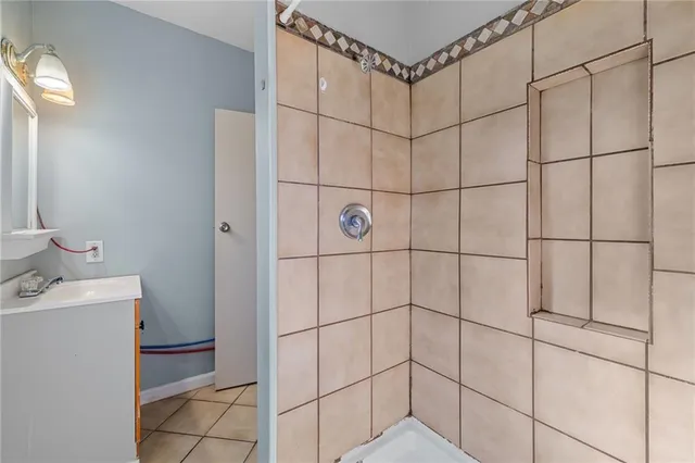 a bathroom with a shower and a sink