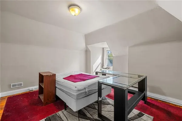 an aerial view of a house with a yard and large trees