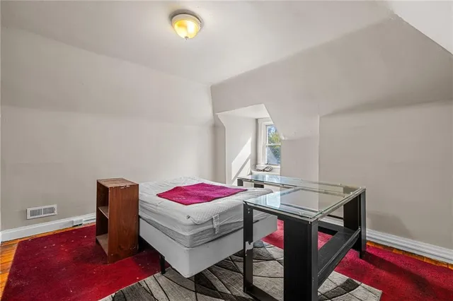 an aerial view of a house with a yard and large trees