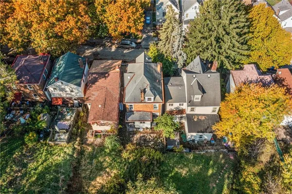 a aerial view of a house with swimming pool and a yard