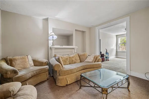 a living room with furniture and a potted plant