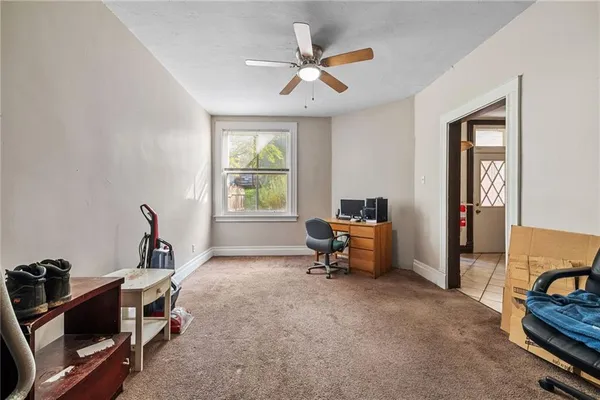 a view of a workspace with furniture and a window
