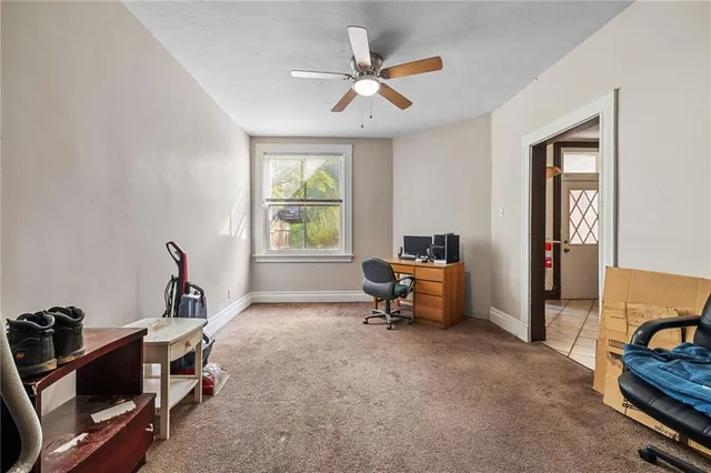 a view of a workspace with furniture and a window