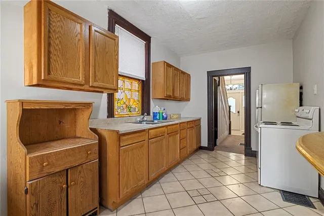 a kitchen with a sink cabinets and appliances