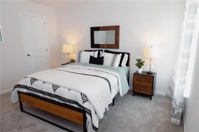 a bedroom with a bed and a lamp