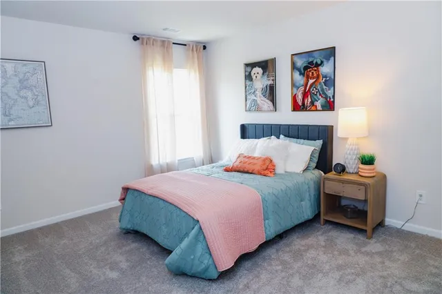 a bedroom with a bed and cabinets