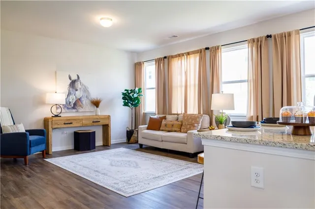 a living room with furniture fireplace and window