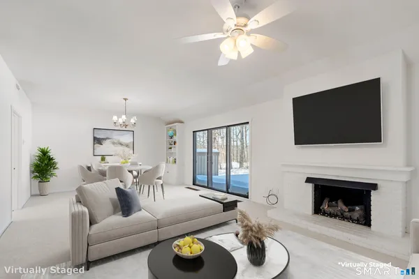 a living room with furniture a fireplace and a flat screen tv