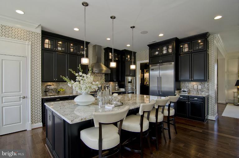 1407 Ridgeview Way Washington, DC 20007 - Photo 4 of 30 a kitchen with a dining table cabinets and refrigerator