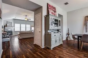 a kitchen view with furniture a wooden floor and a large window